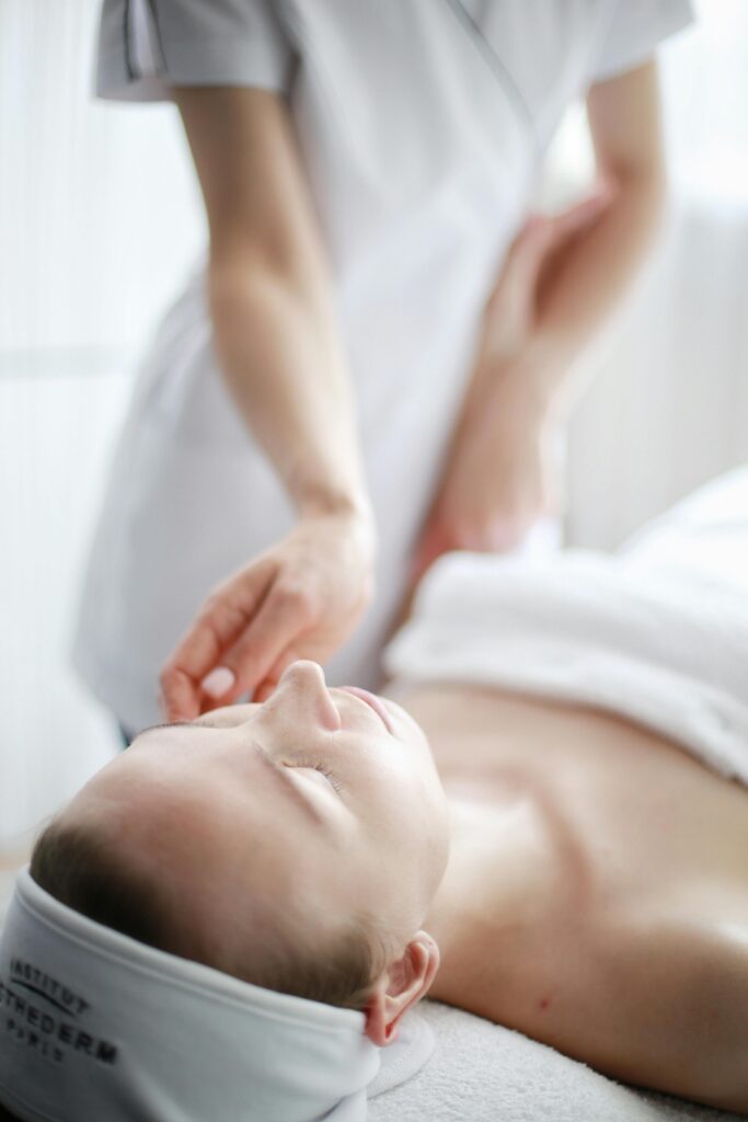 Woman receiving a calming massage therapy session at a spa with focus on relaxation.